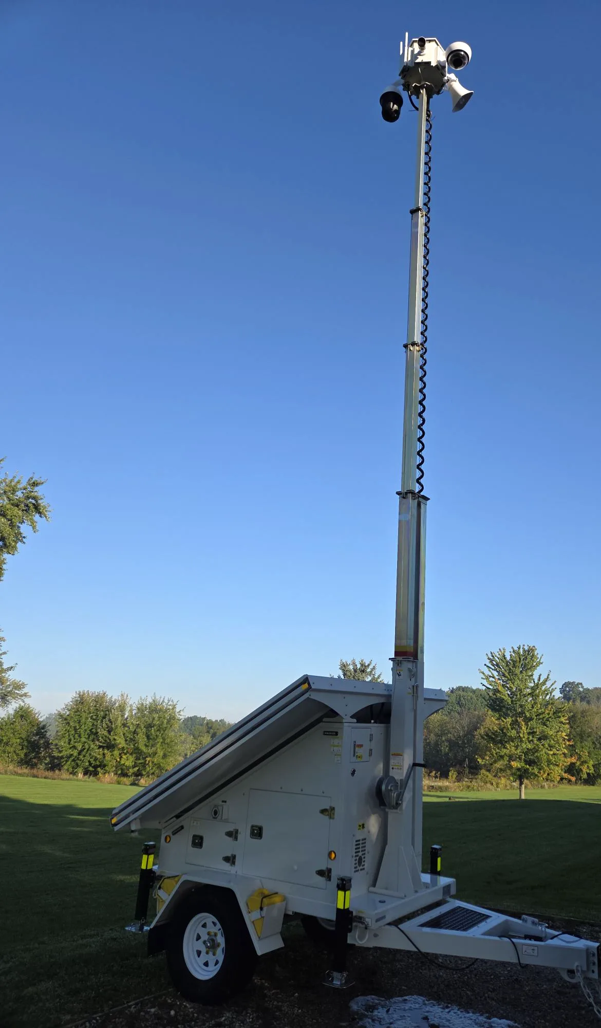 The VB4-MST set up on grass with the mast fully raised and the camera head against a clear sky